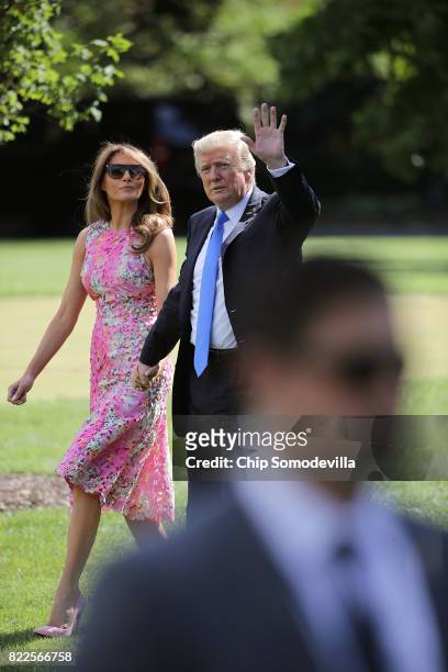 President Donald Trump and first lady Melania Trump walk across the South Lawn before departing the White House July 25, 2017 in Washington, DC....