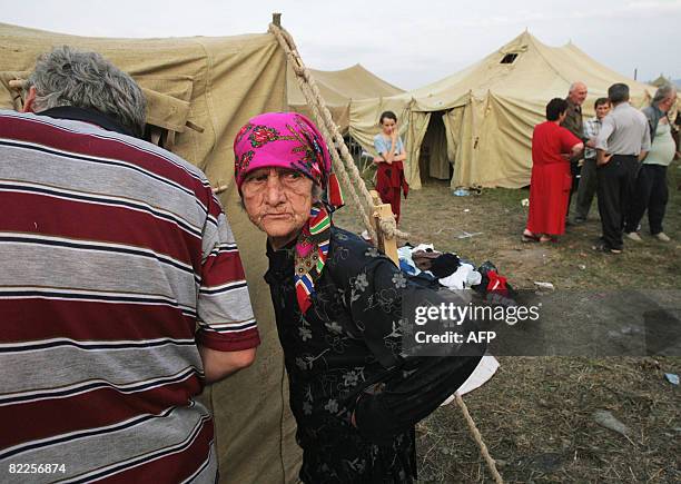 An elderly refugee from South Ossetia looks on in a camp visited by French Foreign Minister Bernard Kouchner on August 11 near the village of Alagir,...