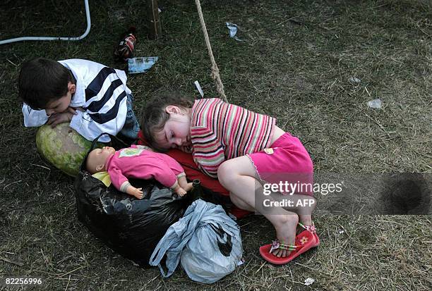 Children from South Ossetia wait in a refugee camp visited by French Foreign Minister Bernard Kouchner on August 11 near the village of Alagir, in...