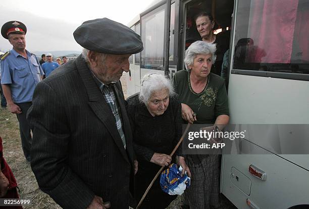 An elderly woman from South Ossetia is helped as she arrives in a refugee camp visited by French Foreign Minister Bernard Kouchner on August 11 near...