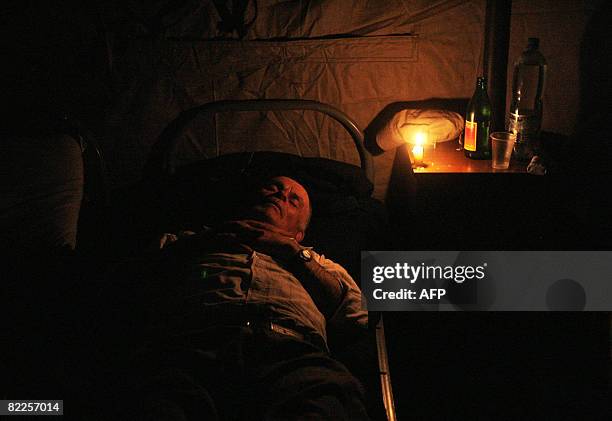 An elderly from South Ossetia lies on a bed in a refugee camp visited by French Foreign Minister Bernard Kouchner on August 11 near the village of...