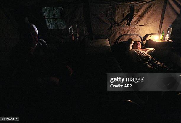 Elderly from South Ossetia try to sleep in a refugee camp visited by French Foreign Minister Bernard Kouchner on August 11 near the village of...