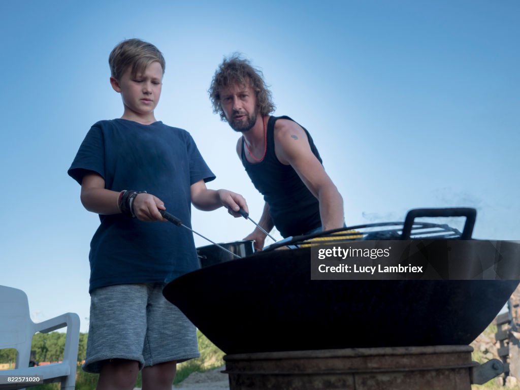 Boy preparing food with his father