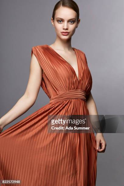 woman in orange dress - neckline stock pictures, royalty-free photos & images