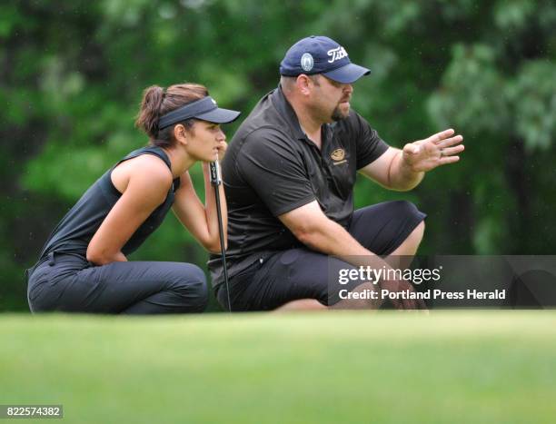 The Maine Women's Amateur golf tournament's opening day. Elizabeth Lacognata gets some advise from caddie Dan Allen on the 18th green. Lacognata's 74...