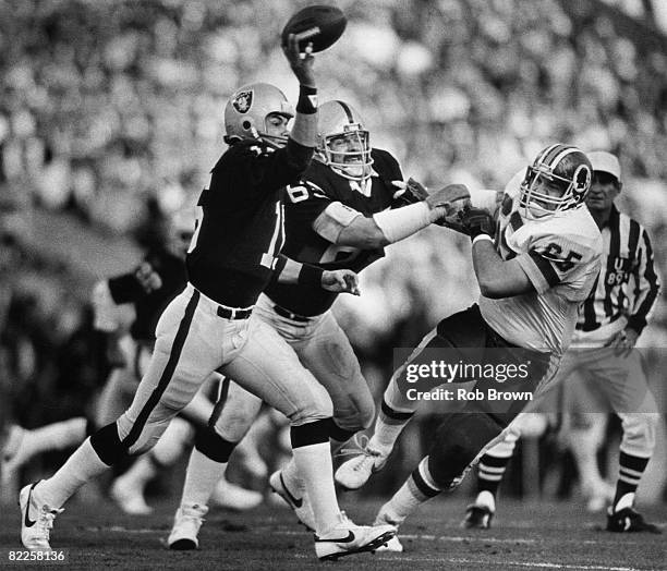 Los Angeles Raiders quarterback Jim Plunkett throws a pass in a 38-9 win over the Washington Redskins in Super Bowl XVIII in January 22,1984 at Tampa...