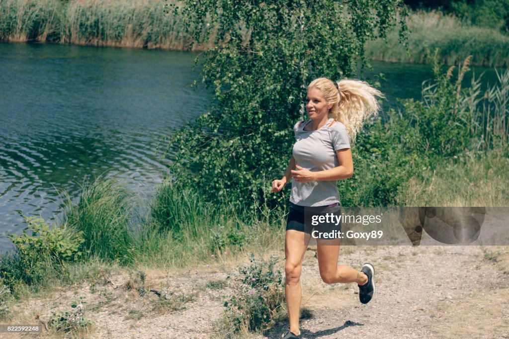 Sporty young woman is training outside