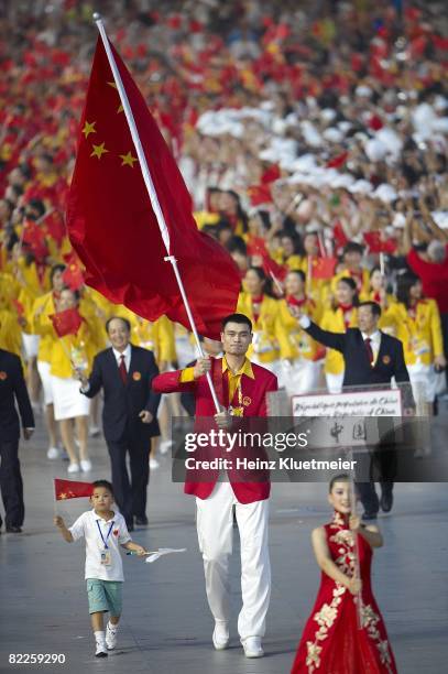 Summer Olympics: Team China national flag bearer Yao Ming with nine-year-old earthquake youth survivor Lin Hao and delegation during athlete...