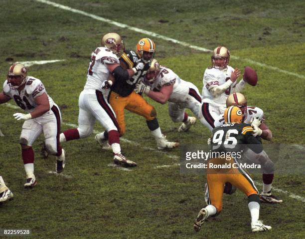 Steve Young of the San Francisco 49ers goes back to pass during the NFL Divisional Playoff Game against the Green Bay Packers on January 4, 1997 in...