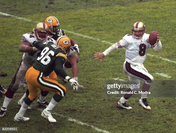 Steve Young of the San Francisco 49ers scrambles during the NFL Divisional Playoff Game against the Green Bay Packers on January 4, 1997 in Green...