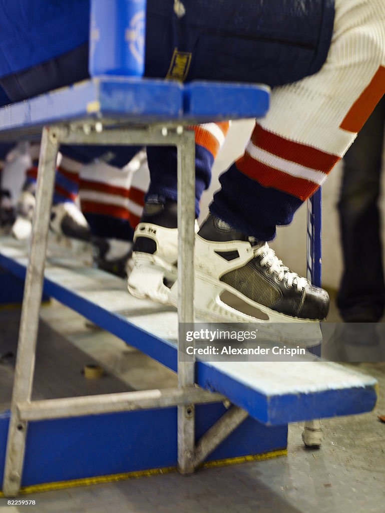 The feet of a ice hockey player.