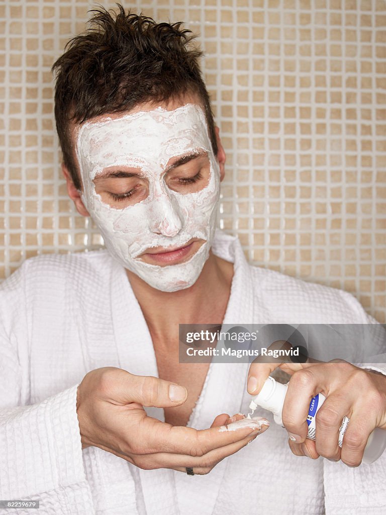 A Scandinavian man using face-cream.