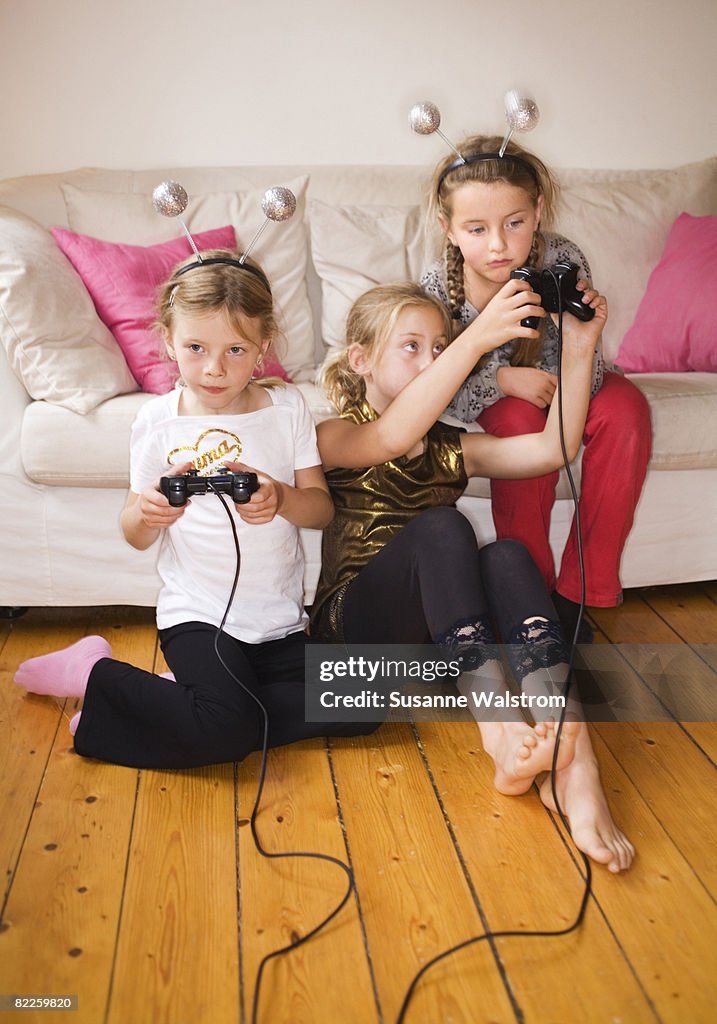 Three girls playing video game Sweden.