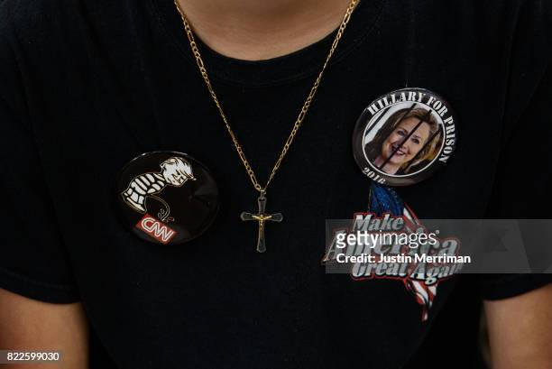 Tyler Selvage of Springfield, Ohio wears campaign buttons on his shirt at a rally where U.S. President Donald Trump is scheduled to attend on July...
