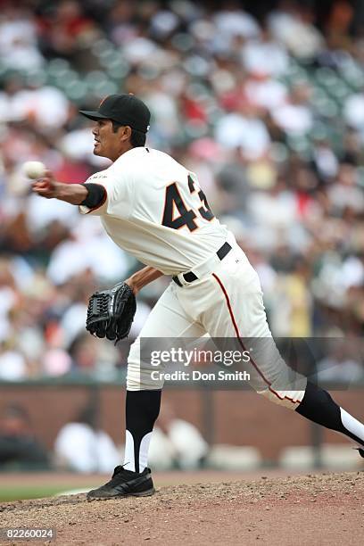 Geno Espineli of the San Francisco Giants pitches in his Major League debut during the game against the Milwaukee Brewers at AT&T Park in San...