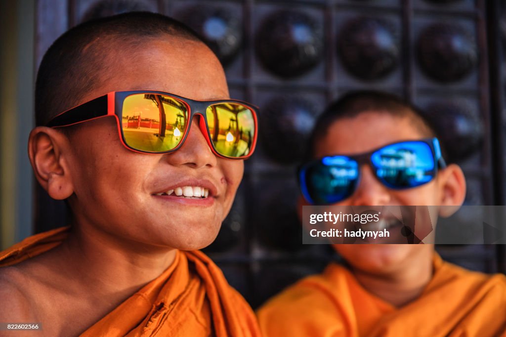 Happy Novice Buddhist monks wearing sunglasses, Bhaktapur