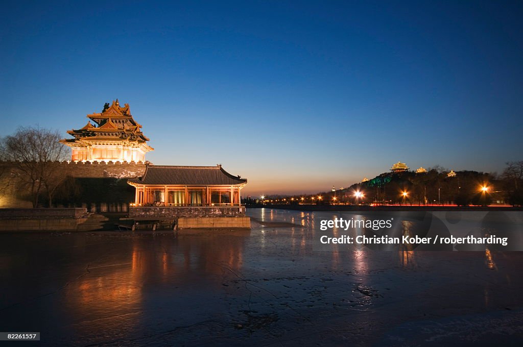 Forbidden City Palace Museum moat and Jingshan Park pavilions illuminated at night, UNESCO World Heritage Site, Beijing, China, Asia