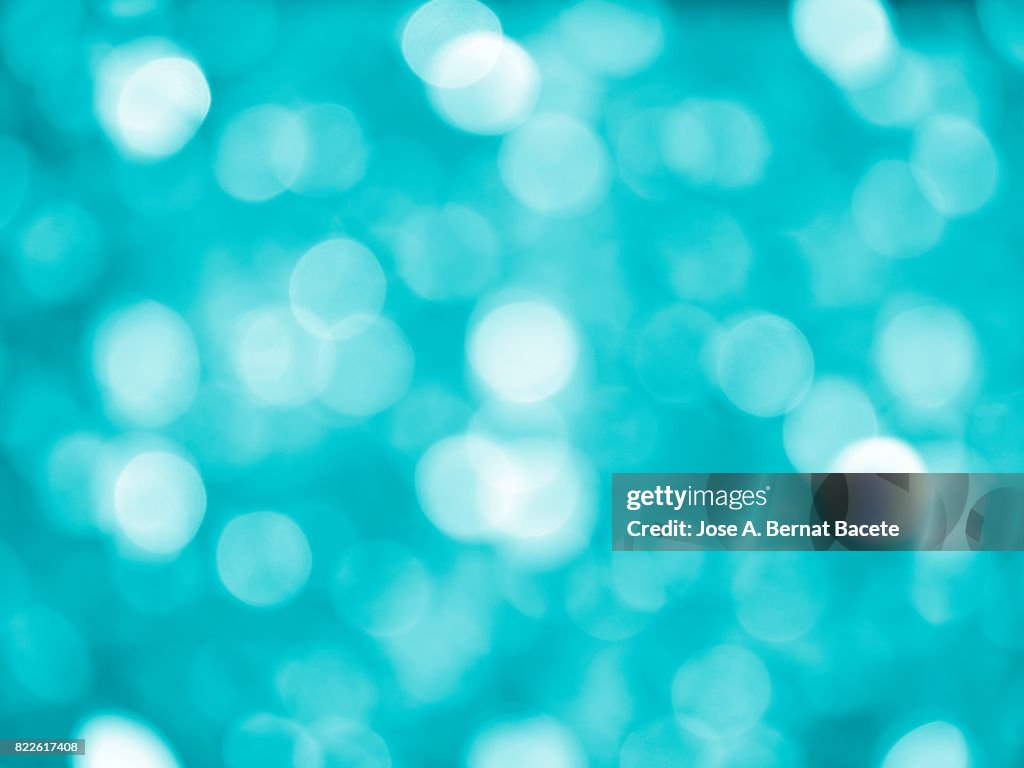 Close-up unfocused lights in the shape of circles of vintage blue background
