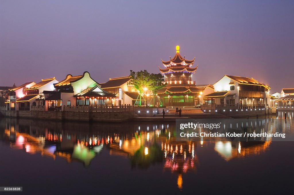 Traditional old riverside houses and pagoda illuminated at night in Shantang water town, Suzhou, Jiangsu Province, China, Asia