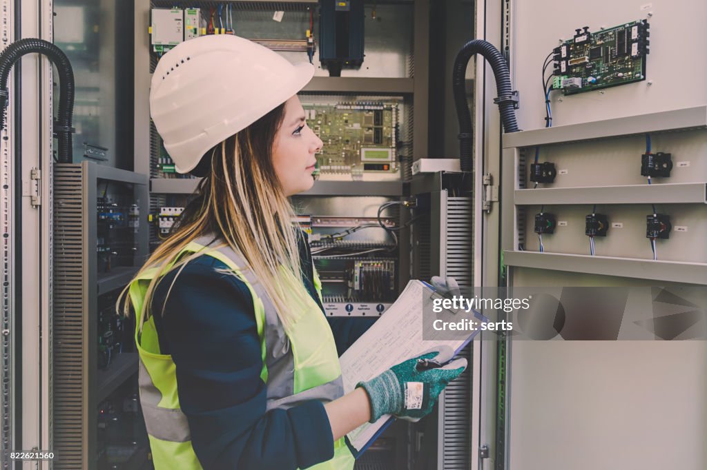 Female Energy Station Electrician Engineer Working at Energy Control Room
