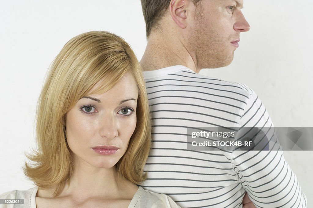 Frustrated couple standing back to back