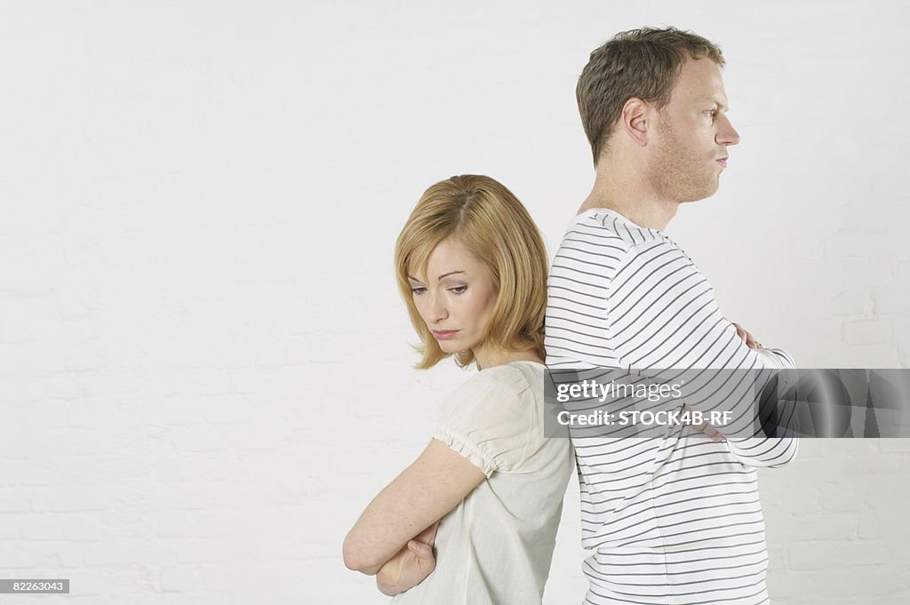 Frustrated couple standing back to back