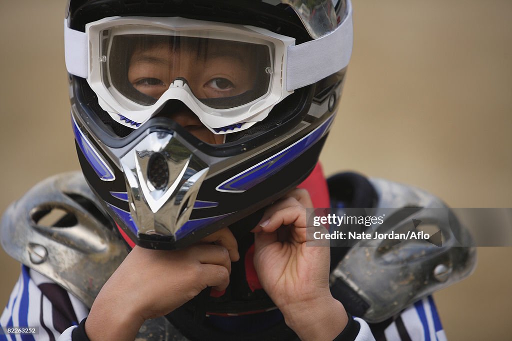 Boy Taking off Helmet