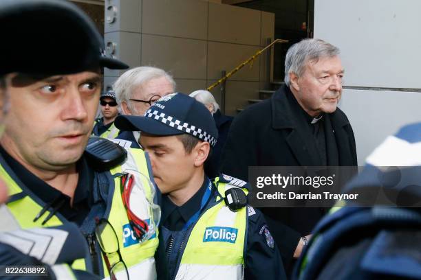 Cardinal Pell walks with a heavy Police guard to the Melbourne Magistrates' Court on July 26, 2017 in Melbourne, Australia. Cardinal Pell was charged...