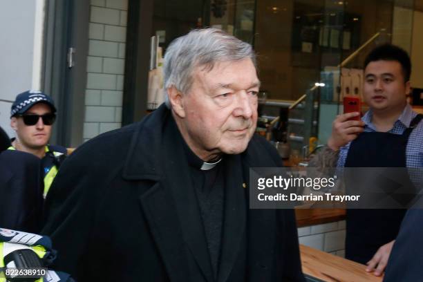Cardinal Pell walks with a heavy Police guard to the Melbourne Magistrates' Court on July 26, 2017 in Melbourne, Australia. Cardinal Pell was charged...
