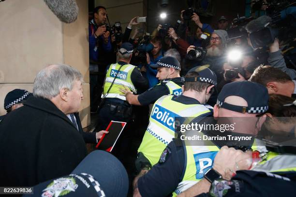 Cardinal Pell walks with a heavy police guard to the Melbourne Magistrates' Court on July 26, 2017 in Melbourne, Australia. Cardinal Pell was charged...