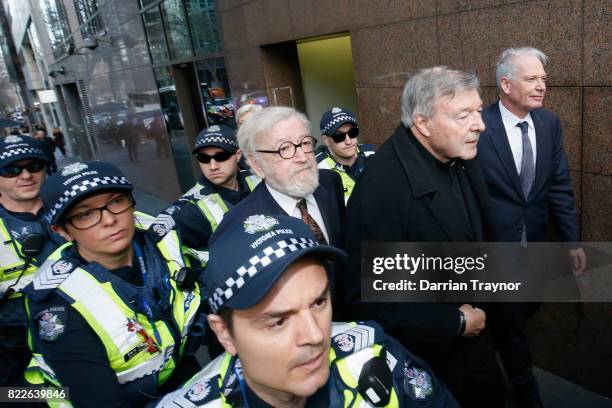 Cardinal Pell walks with a heavy police guard to the Melbourne Magistrates' Court on July 26, 2017 in Melbourne, Australia. Cardinal Pell was charged...