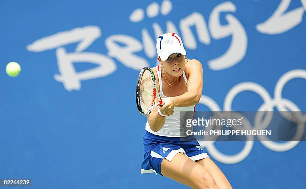 France's Alize Cornet hits a return against Peng Shuai of China during their women's singles second round tennis match at the 2008 Beijing Olympic...