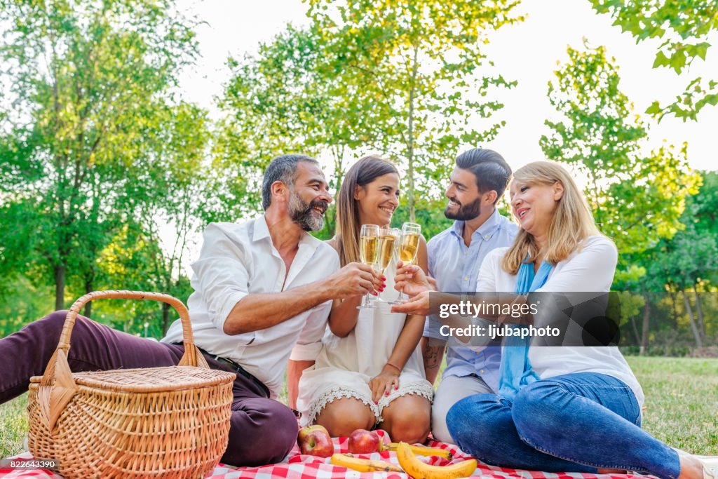 Happy friends or family with glasses of champagne