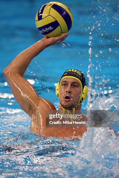 Thomas Whalen of Australia looks to throw the ball while taking on Spain in their preliminary round water polo match held at the Yingdong Natatorium...