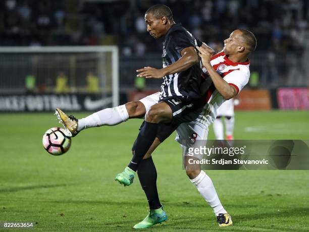 Leandre Tawamba of Partizan competes for the ball against Vadis Odjidja of Olympiacos during the UEFA Champions League Qualifying match between FC...