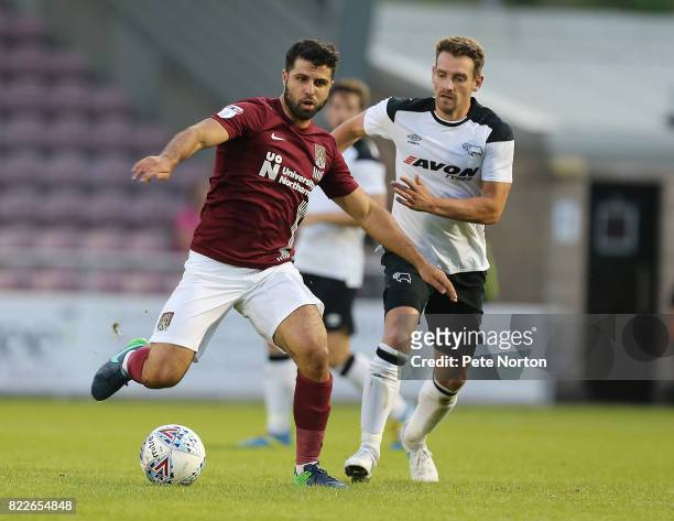 Yaser Kasim of Northampton Town controls the ball watched by Craig Bryson of Derby County during the Pre-Season Friendly match between Northampton...