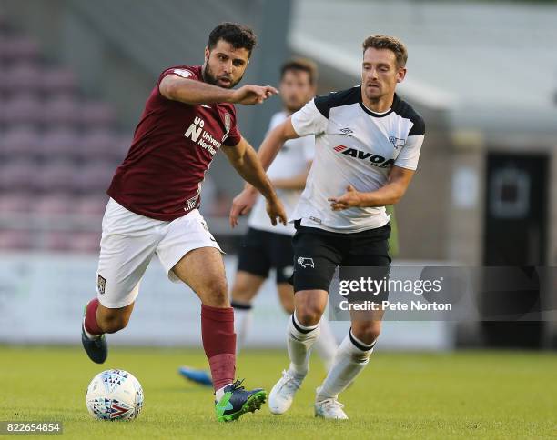 Yaser Kasim of Northampton Town controls the ball watched by Craig Bryson of Derby County during the Pre-Season Friendly match between Northampton...