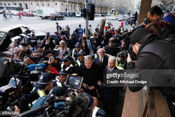 Cardinal George Pell walks with a heavy Police guard to the Melbourne Magistrates' Court on July 26, 2017 in Melbourne, Australia. Cardinal Pell was...