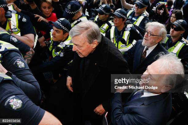 Cardinal George Pell walks with a heavy Police guard to the Melbourne Magistrates' Court on July 26, 2017 in Melbourne, Australia. Cardinal Pell was...