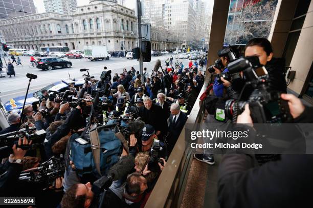 Cardinal George Pell walks with a heavy Police guard to the Melbourne Magistrates' Court on July 26, 2017 in Melbourne, Australia. Cardinal Pell was...