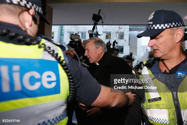 Cardinal George Pell walks with a heavy Police guard to the Melbourne Magistrates' Court on July 26, 2017 in Melbourne, Australia. Cardinal Pell was...
