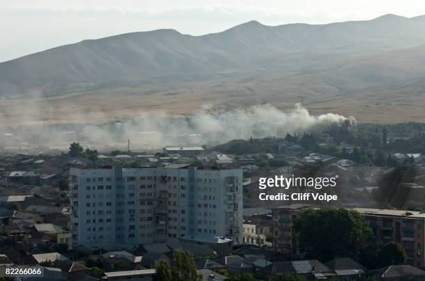 Smoke billows from civilian apartment buildings that were bombed by Russian jets August 11, 2008 in Gori, Georgia. Russian forces have advanced into...