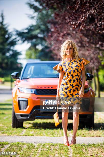 Justine Mattera wearing a Mauro Gasperi orange dress, Alef orange bag and Giovanni Fabiani shoes, is seen ahead of her Range Rover on July 18, 2017...