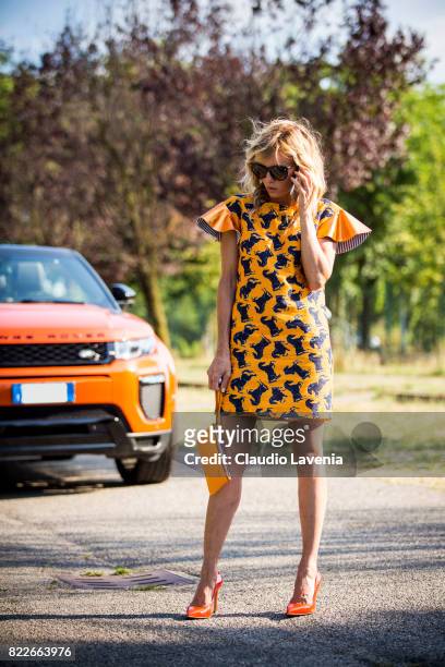 Justine Mattera wearing a Mauro Gasperi orange dress, Alef orange bag, Dsquared2 sunglasses and Giovanni Fabiani shoes, is seen ahead of her Range...