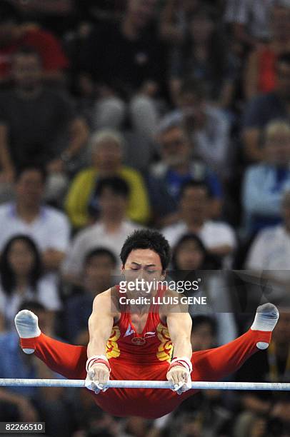 China's Kai Zou competes on the horizontal bars during the men's team final of the artistic gymnastics event of the Beijing 2008 Olympic Games in...