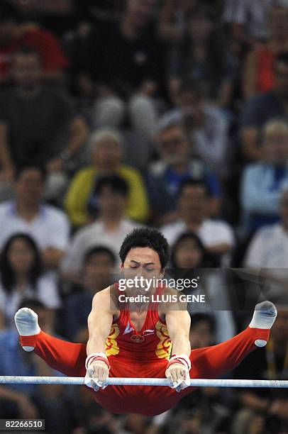 China's Kai Zou competes on the horizontal bars during the men's team final of the artistic gymnastics event of the Beijing 2008 Olympic Games in...