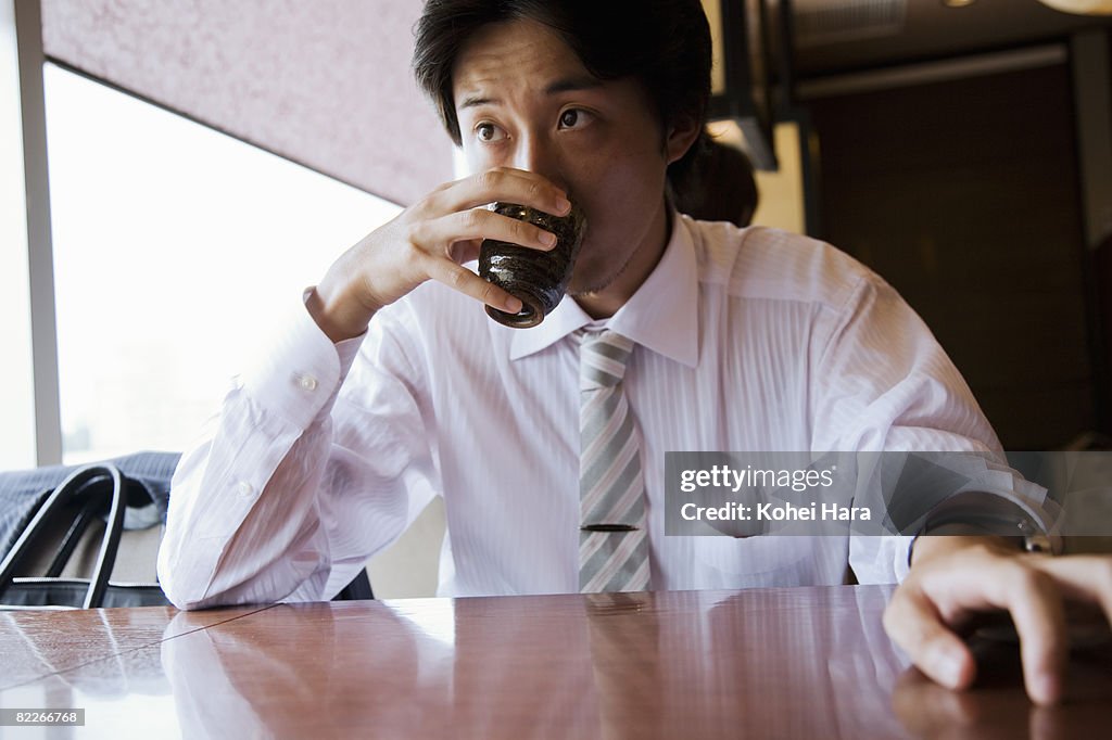 A business man drinking tea at a restaurant