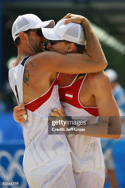 Clemens Doppler and Peter Gartmayer of Austria celebrate their victory in the Men's Preliminary Pool D match against Marcio Araujo and Fabio Luiz...