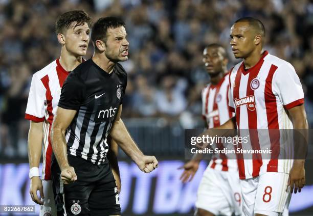 Bojan Ostojic of Partizan reacts near Vadis Odjidja and Panagiotis Retsos of Olympiacos during the UEFA Champions League Qualifying match between FC...