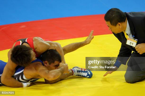 Armen Nazarian of Bulgaria looks towards the referee as he competes against Makoto Sasamoto of Japan in their Men's Greco-Roman 60 kg quarterfinal...